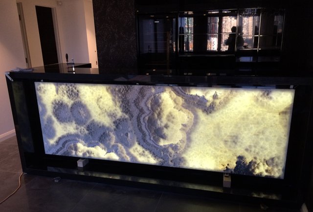 backlit amber onyx and black granite benchtop